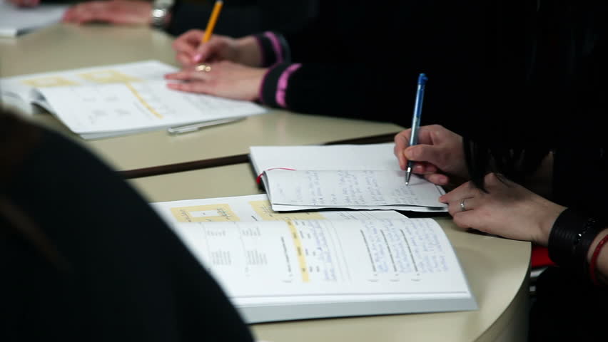 Students writing after teacher dictation