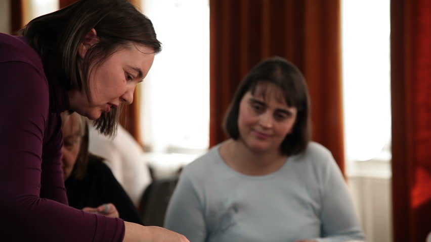 Old women learning how to knit and showing their products