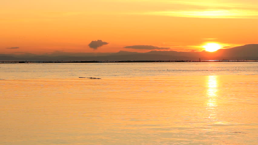 Tugboat at Sunset, Steveston. A tugboat heads out of the Fraser River at sundown and into Georgia Strait. British Columbia, Canada.
