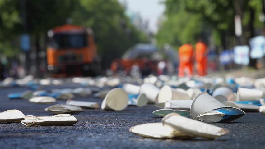 garbage trucks and collectors doing fast job after marathon