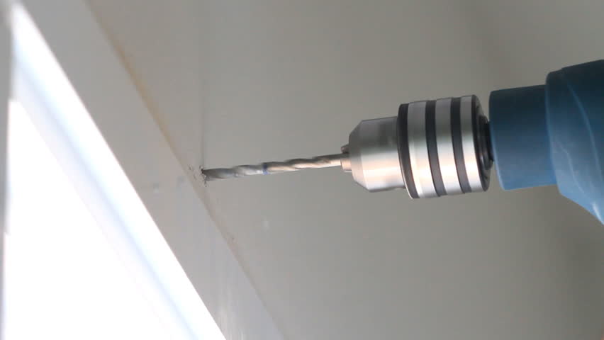 drilling hole into concrete wall