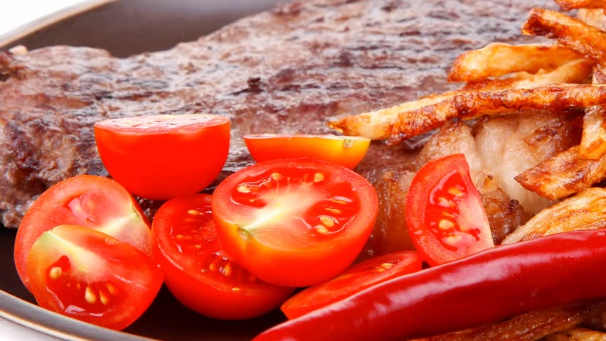 main course : grill beef steak with potato chips and fresh cherry tomato red hot chili peppers on plate 1920x1080 intro motion slow hidef hd