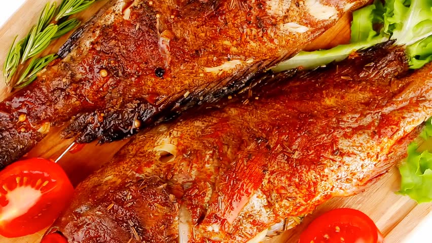 main portion of two grilled fish served on wooden plate 1920x1080 intro motion slow hidef hd
