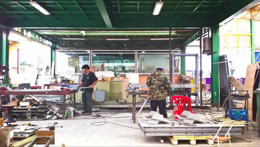 Bangkok, Thailand - May 2013 : Time lapse of workers welding and bright sparks in furniture factory