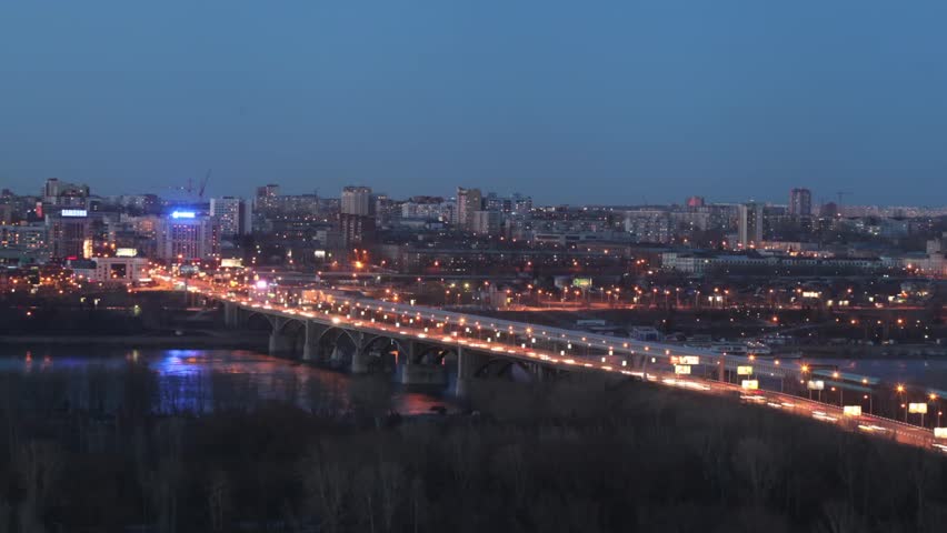 The bridge over the river at night with moving cars