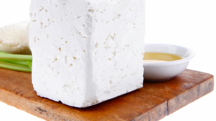 dairy product : fresh raw white soft greek feta cheese cubes and round on wooden plate 1920x1080 intro motion slow hidef hd