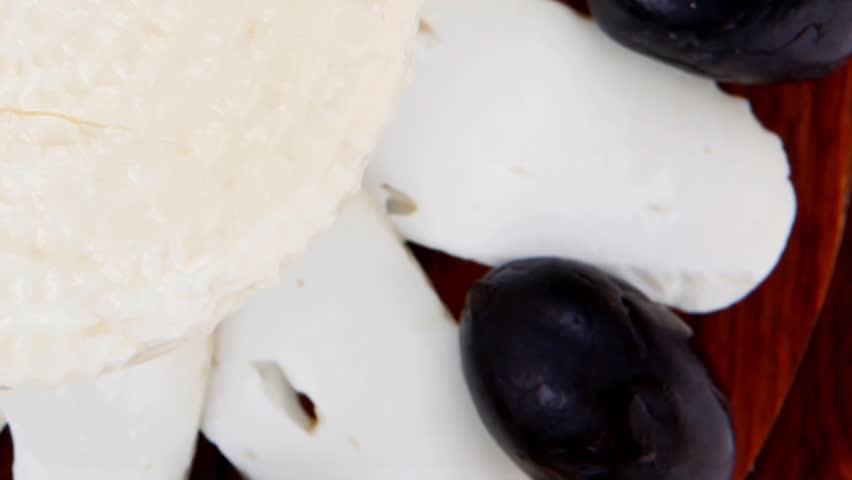 dairy products : feta white cheese sliced on cut board with olives and basil leaves 1920x1080 intro motion slow hidef hd