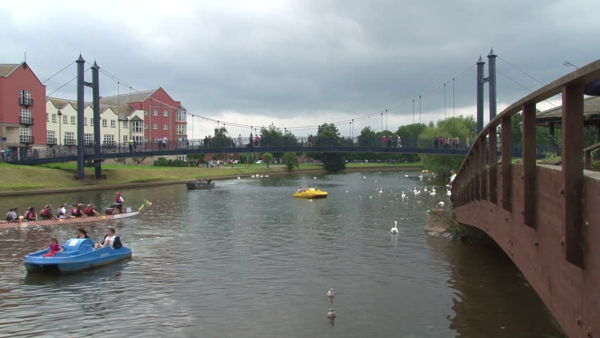 EXETER, UK - SEPTEMBER 2012: Boats and bridges on the River Exe in the city centre of Exeter.