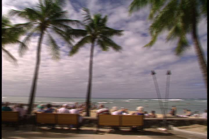WAIKIKI BEACH, HONOLULU, HAWAII - JANUARY 30, 1997: scenic b-roll of Waikiki Beach, Hawaii: fast spinning clockwise panorama of beach, palm trees, hotel and people.