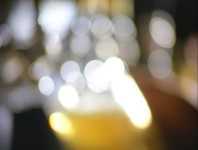 A pint of lager beer being poured from the tap in a pub.