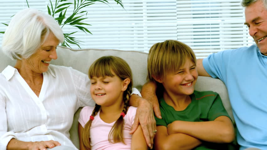 Children with grandparents on the couch in slow motion at 250 frames per second