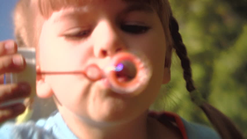 Sequence of soft focus shots. Happy Mum with the little girl playing in the park