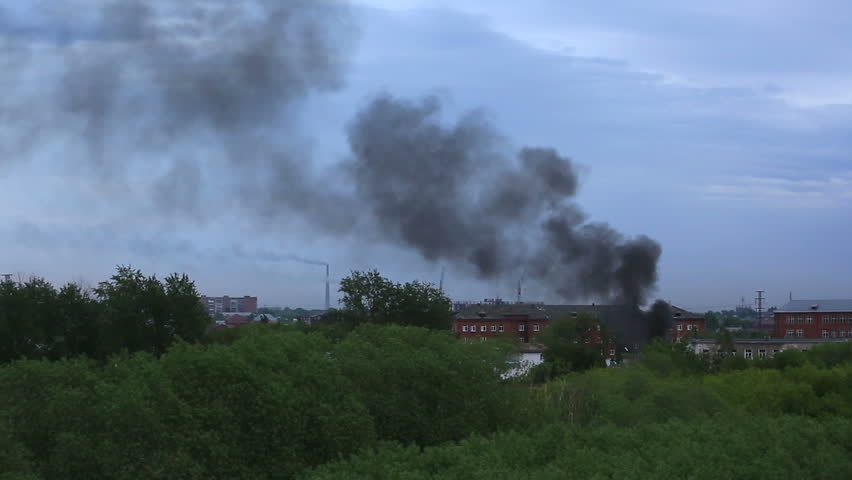 Black smoke in a residential area. Fire in Omsk. Russia.