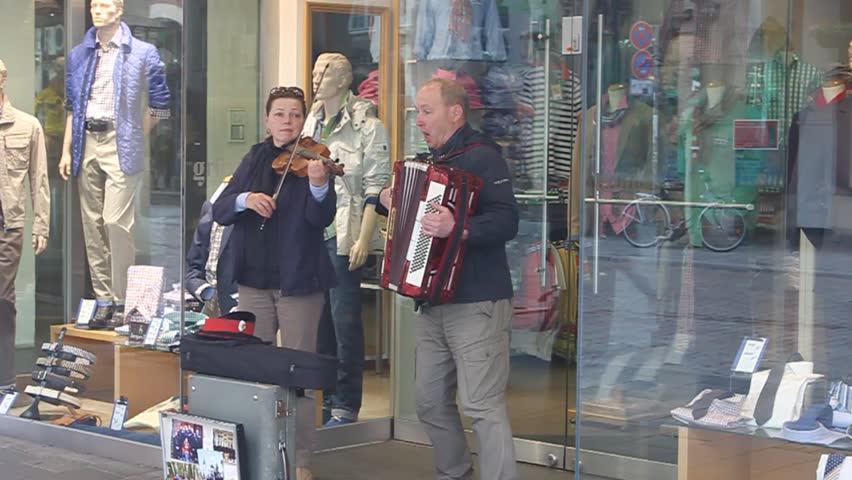 MUENSTER, GERMANY - MAY 9: Duo of street artists plays famous russian songs on May 9, 2013 in Muenster, Germany
