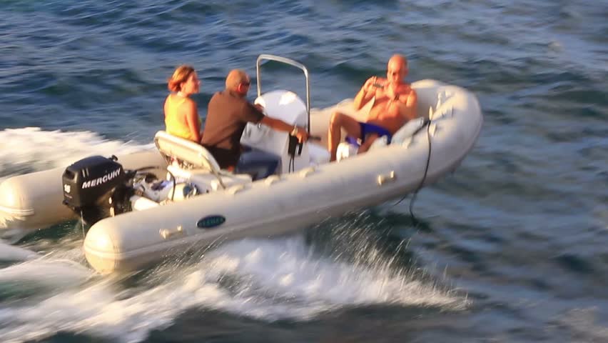 ISTANBUL - SEP 3: Tourists having fun with an inflatable boat at Bosphorus Sea on September 3, 2012 in Istanbul, Turkey. Powerboat heading out to sea at high speed leaving white wake. 
