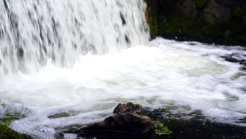 Small waterfall in creek. Slow motion