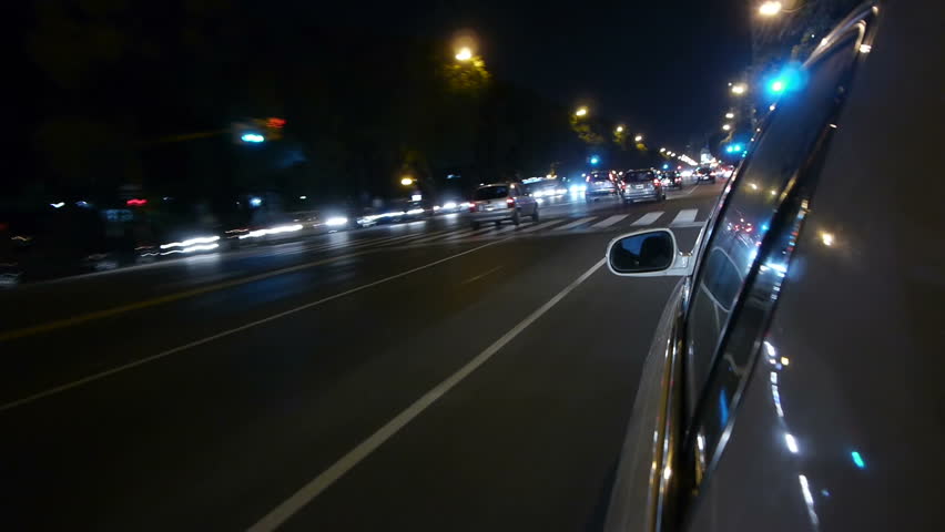 Driving a car time-lapse. Night, Camera gripped on the side / reference. POV - point of view. White car ride. City, blurred motion, fast driving. HD.