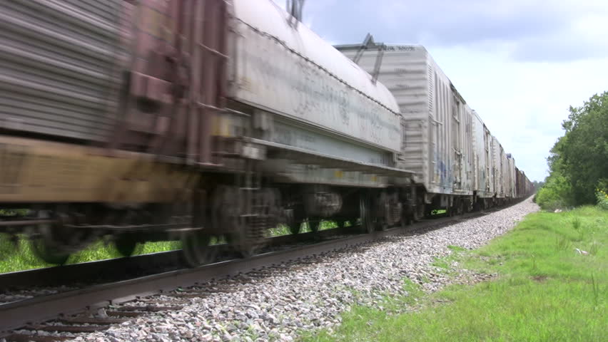 Video of a Union Pacific freight train passing by. Middle of train with various different cars passing high speed. Green Texas. Don Despain of Rekindle Photo