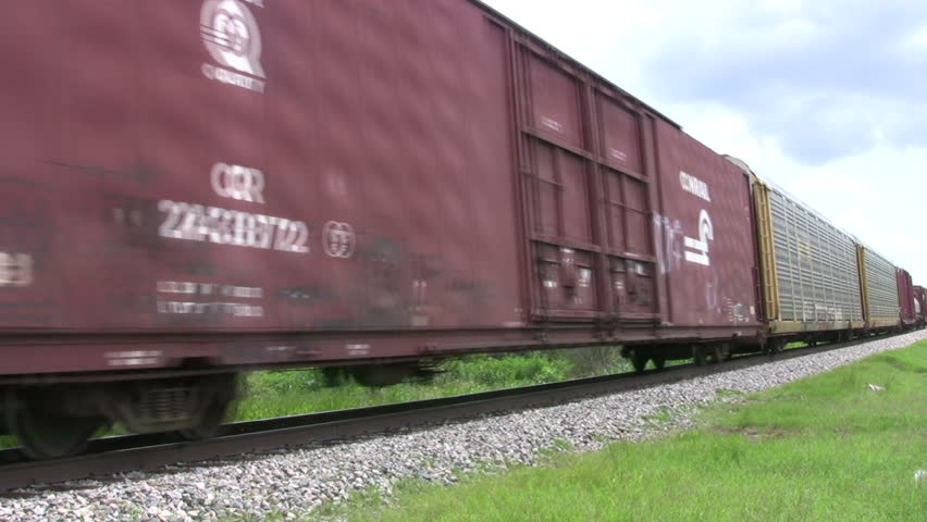 Video of a Union Pacific freight train passing by. Middle to end of train.  With various different cars passing high speed. Green Texas. Don Despain of Rekindle Photo