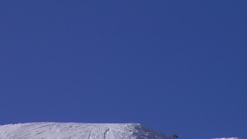 Skiers jumping into the blue sky; 2 shots