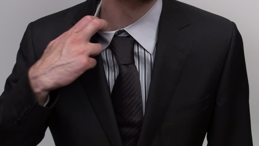 Businessman adjusts tie
