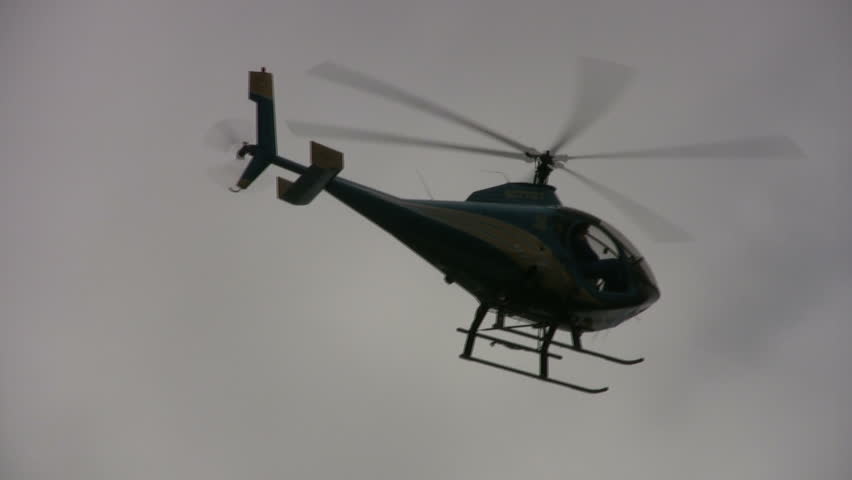 Video of a police helicopter on a circle patrol. Pilot and observer looking for criminal. San Antoniom Texas. Don Despain of Rekindle Photo