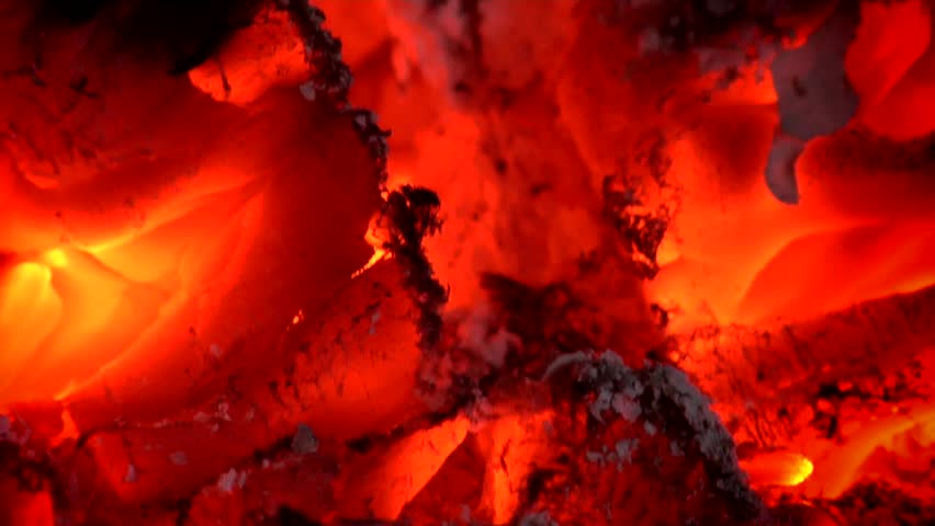 Glowing, blazing wood embers of a dying fire. Clip Four