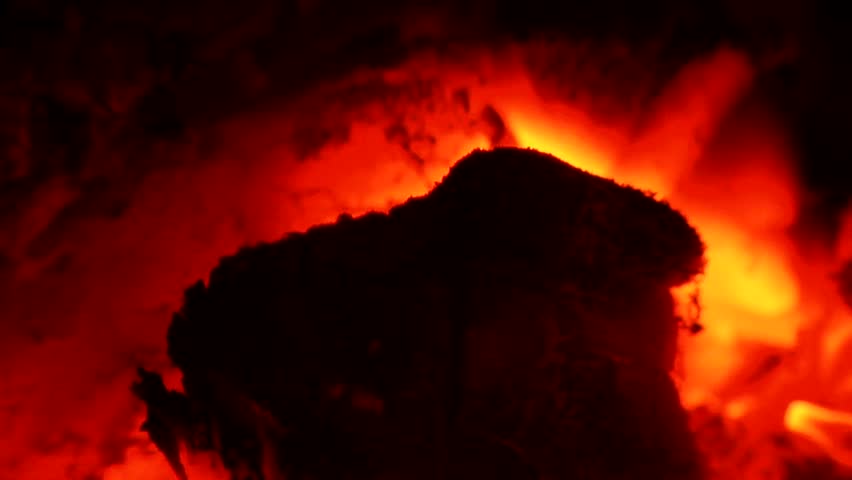 Glowing, blazing wood embers of a dying fire. Clip Five