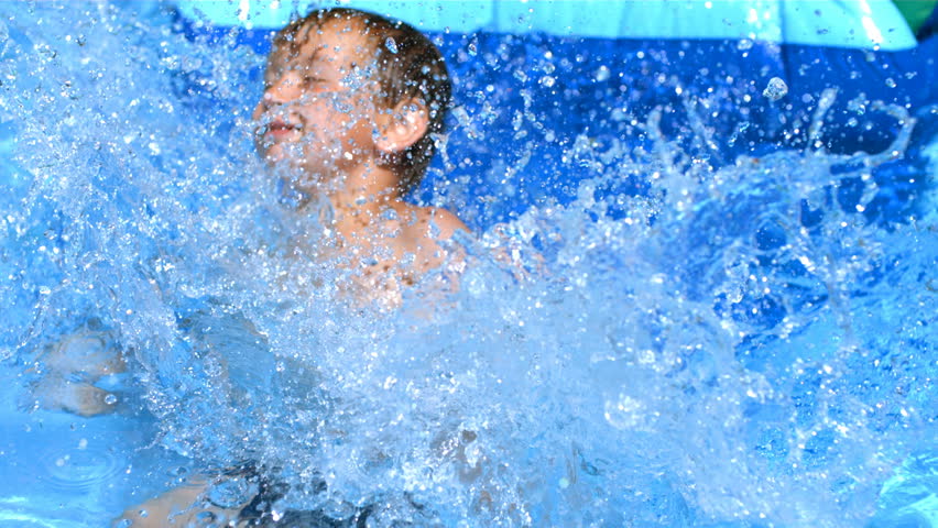 Young boy playing on water slide