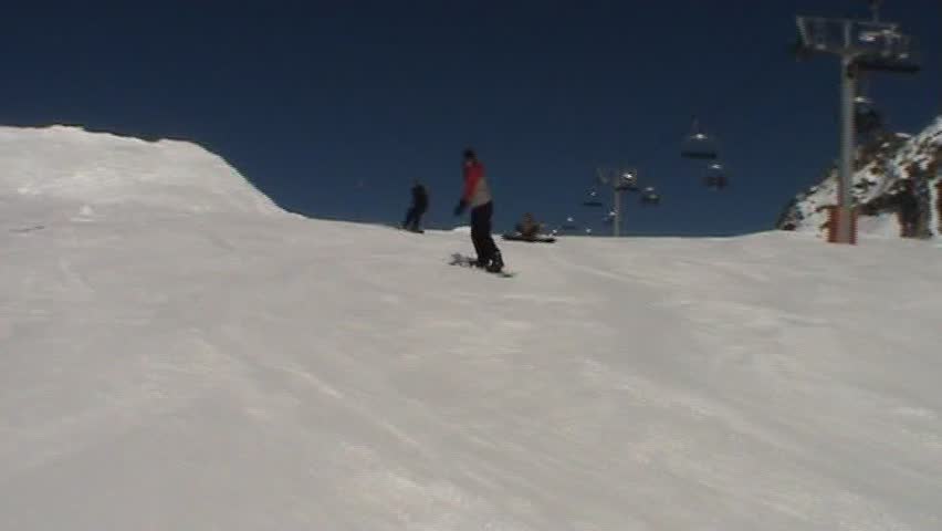 Snowboarder carving his way down mountain