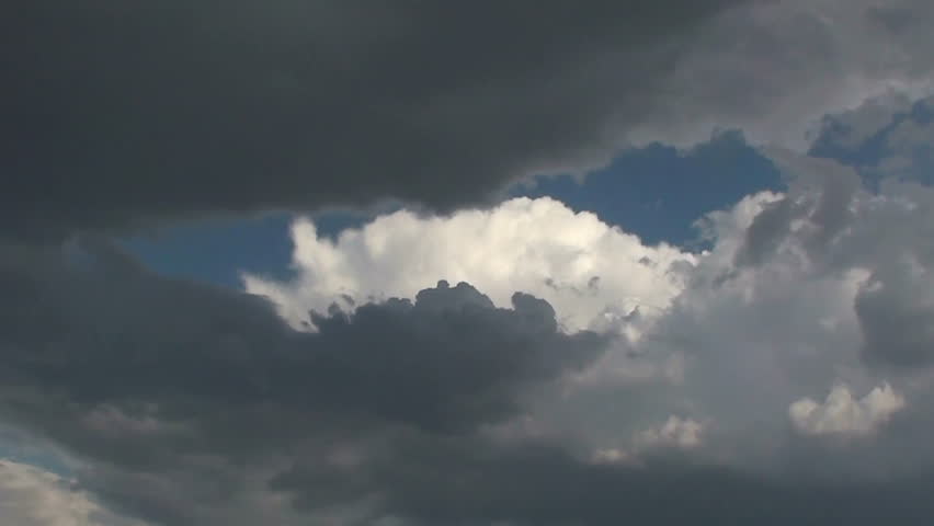  A peek at white puffy clouds through a window of dark stormy ones engulfing them. 1920x1080