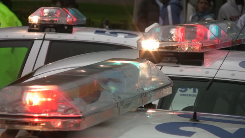 Flashing police car lights. Handheld shot. Toronto, Canada.
