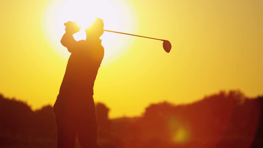 Silhouette male golfer enjoying time golf course in summer driving off down fairway into setting sun shot on RED EPIC, 4K, UHD, Ultra HD resolution
