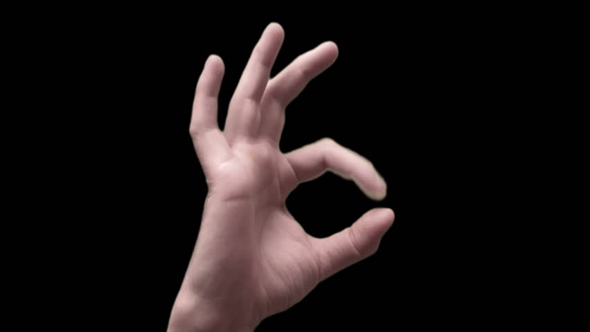 ok hand sign against black