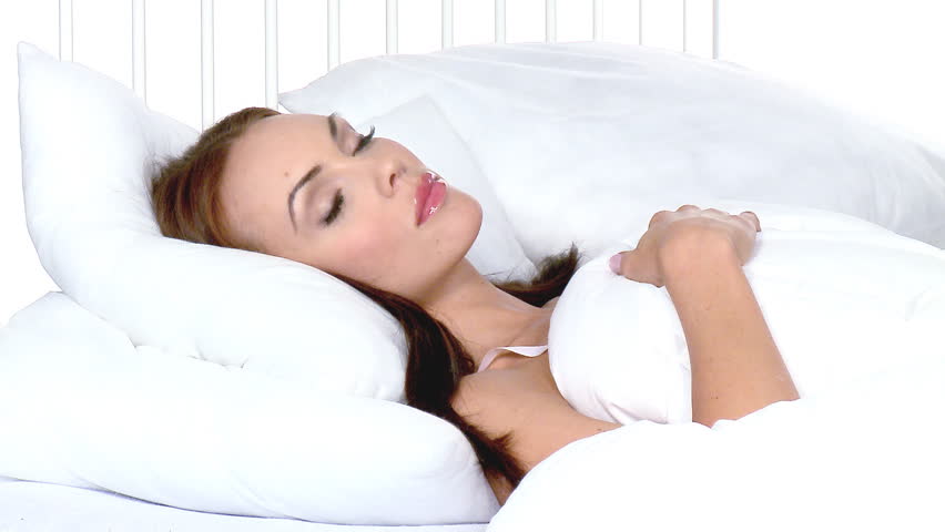 Beautiful woman sleeping on white bed at her home 