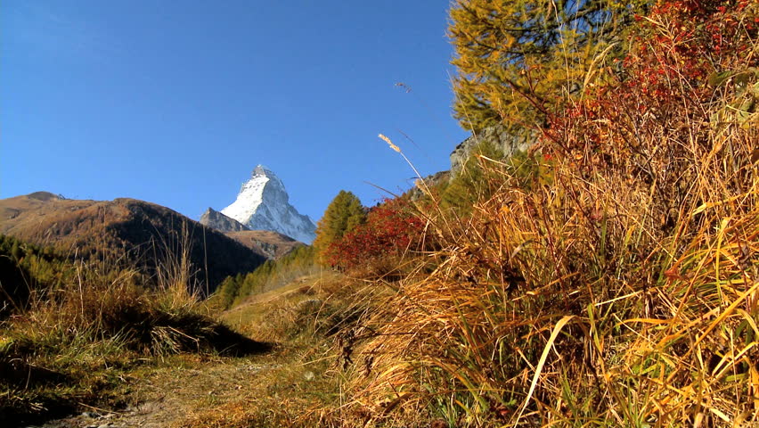 Fall in an alpine meadow, Zermatt, with hikers & the Matterhorn, motion jib