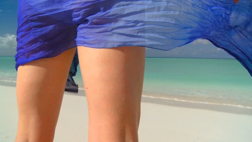 Elegant young female in swimwear on a beautiful white sandy beach looking at aquamarine waters 60 FPS