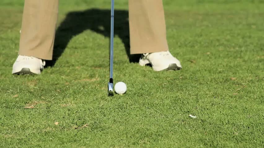 Golf tee shot with an iron on a par 3 hole