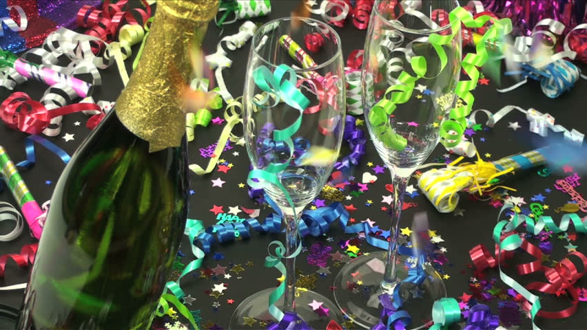 Champagne toast begins with confetti raining around bottle, flute. 