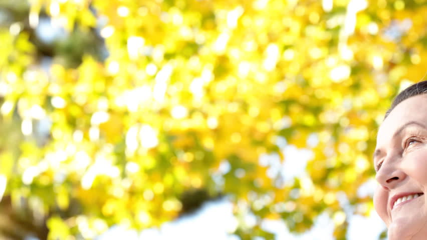 Tight shot of a happy older woman looking serene and peaceful