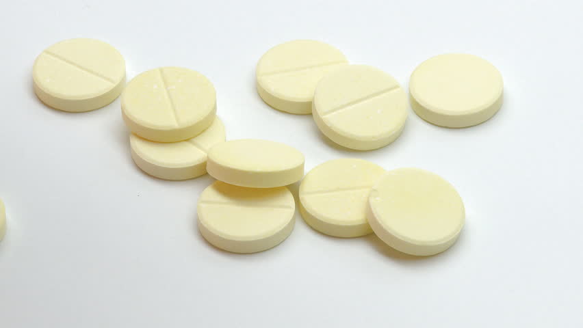 Medicinal pills falling on the table