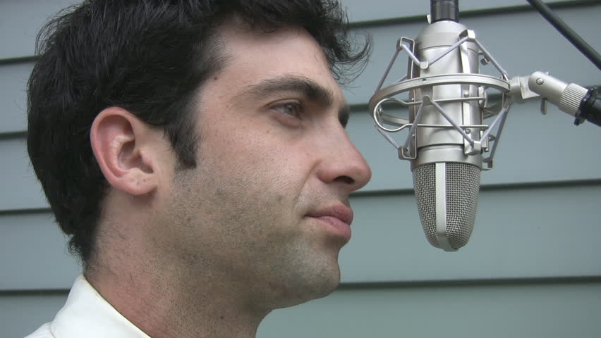 Man talking into a professional condenser microphone. 