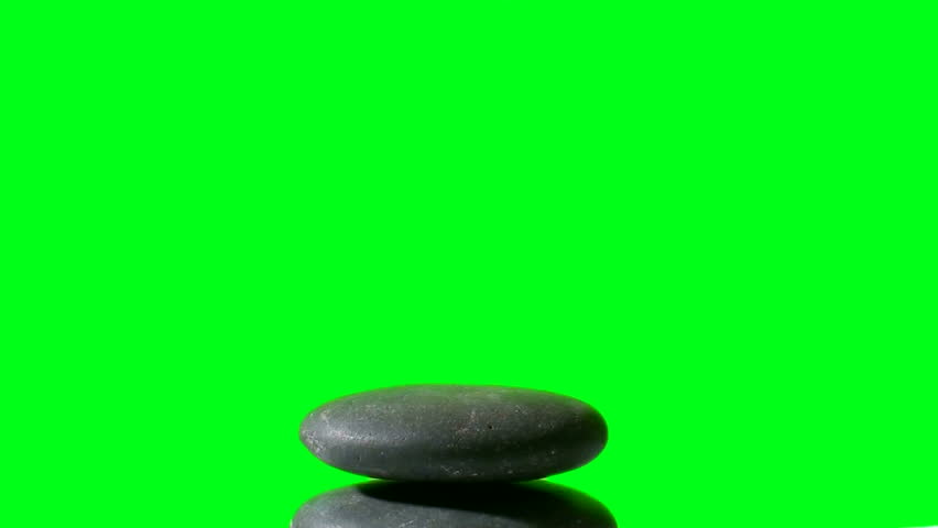 Stack of Zen rocks grows in stop motion against green screen background