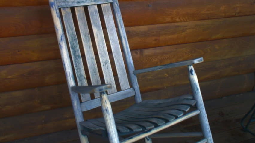 vintage weathered rocking chair on outdoor porch