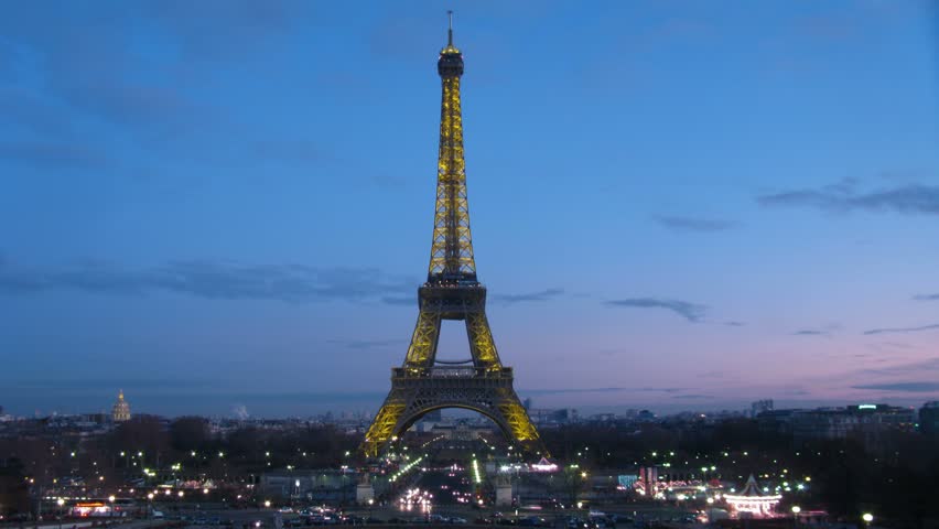 View on night city with illuminated Tour d'Eiffel on the center on sunset sky. Paris, France. Time lapse. 