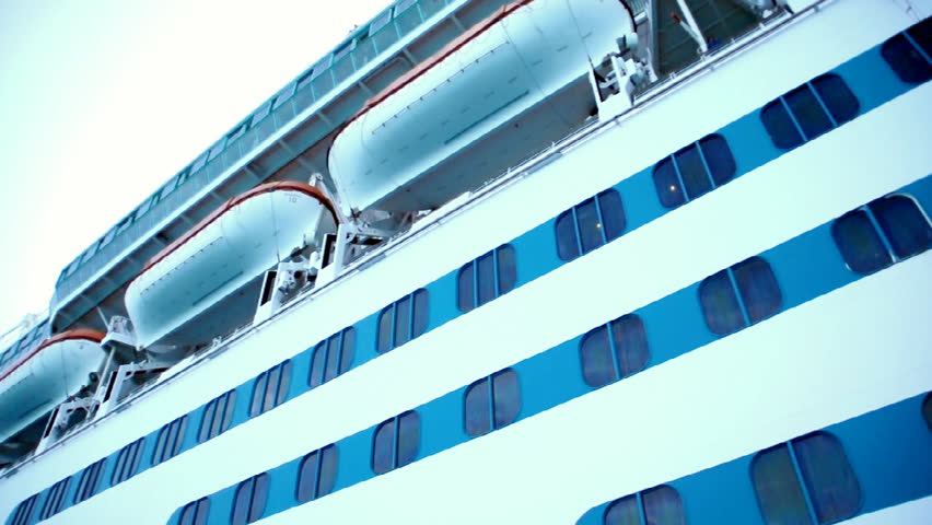 A small tender ship ports passengers to and from a cruise liner.