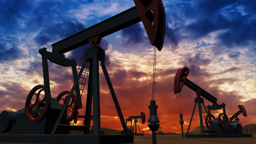 Oil pumps at sunset background