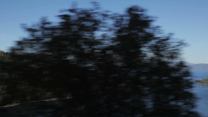 Emerald Bay, Lake Tahoe, California, as seen from a moving vehicle. Note: Tripod-mounted camera, but shaking due to wind is visible at full size.