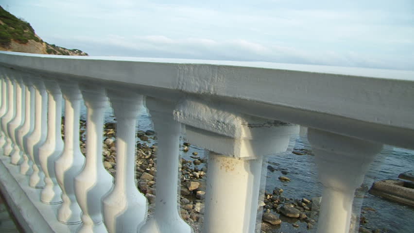Seascape. Moving camera. The beautiful bride and groom admiring the scenery.