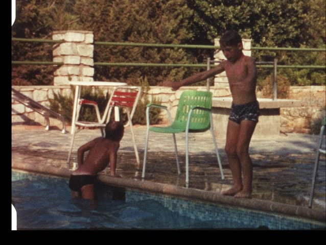 Boy jumping in swimming pool (vintage 8 mm amateur film)